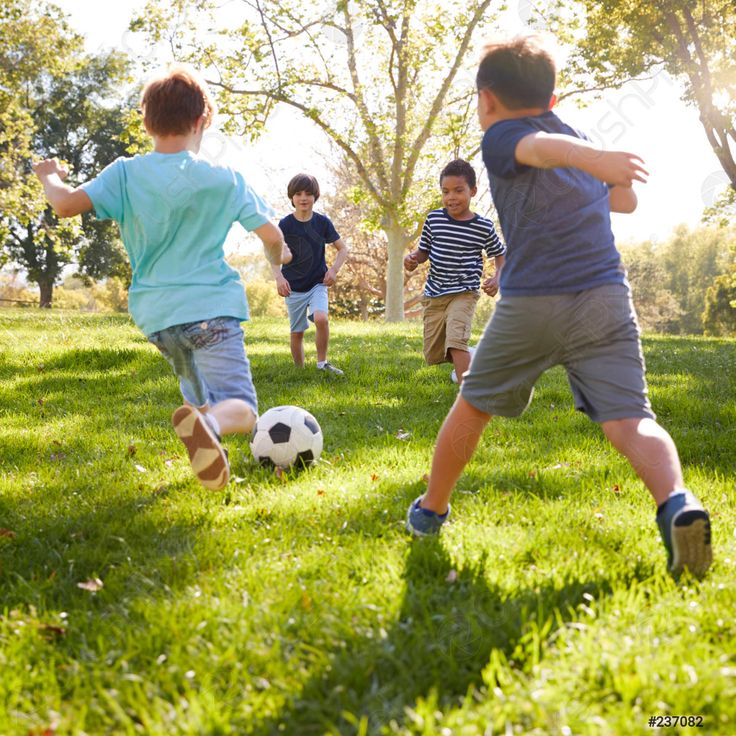 Children playing soccer outdoors.